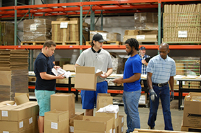Workers prepare boxes for shipping