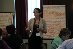 Andrea Landry presents a summary of the working group session on reaching the hard-to-reach