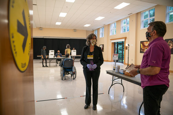 Election workers using protective equipment